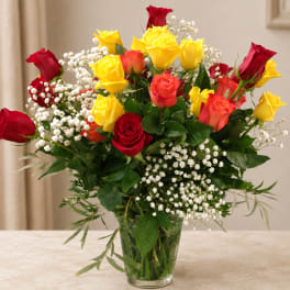 Bouquet of red and yellow roses in a clear glass vase