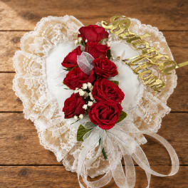 Heart-shaped lace pillow with red roses and gold lettering