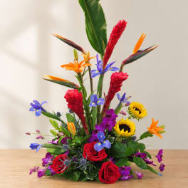 Tropical bouquet with red roses, sunflowers, and orange bird-of-paradise blooms