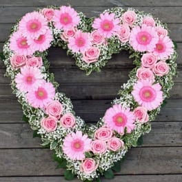 Heart-shaped floral wreath with pink gerbera daisies and roses