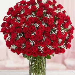 Large bouquet of red roses in a clear glass vase