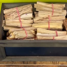 Bundles of split firewood stacked in a wooden crate