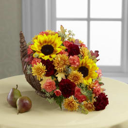 Basket arrangement with sunflowers, chrysanthemums, and carnations