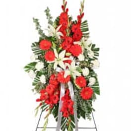 Standing floral spray with red and white flowers on an easel