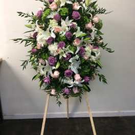 Large standing floral spray with pink, purple, and white flowers