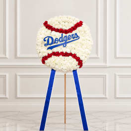 Baseball-shaped floral wreath with red and white flowers and a blue Dodgers logo