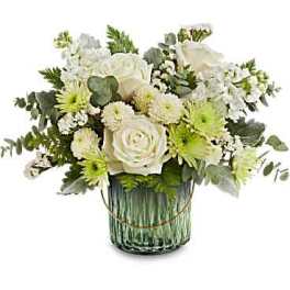 White and green floral arrangement in a glass vase