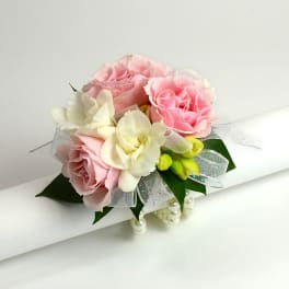 Pink and white rose bouquet with ribbon and pearl accents