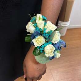 White rose wrist corsage with blue ribbon and turquoise accents