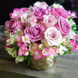 Pink and white rose bouquet in a gold vase