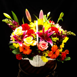 Colorful mixed flower basket with roses, lilies, sunflowers, and gerbera daisies