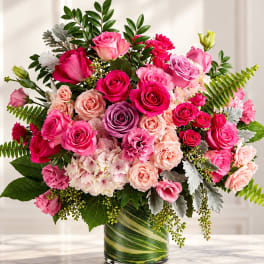 Pink and peach rose bouquet in a glass vase