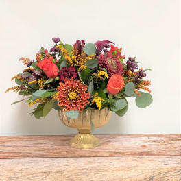 Mixed bouquet in a gold pedestal vase with roses and chrysanthemums
