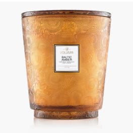 Amber decorative candle jar with a labeled front