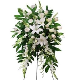 White lily funeral spray on a standing easel