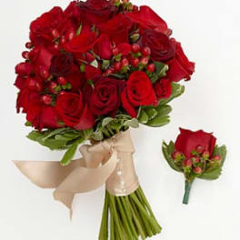 Bouquet of red roses with a beige ribbon and matching boutonniere