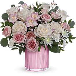 Pink and white roses in a pink glass vase