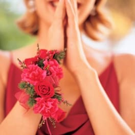 Woman wearing a pink floral wrist corsage