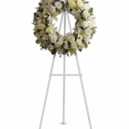 White floral wreath on a standing easel
