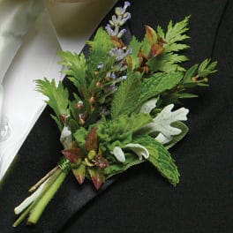 Small boutonniere with green foliage and lavender flowers