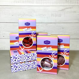 Assorted chocolate truffle gift boxes stacked on a tabletop