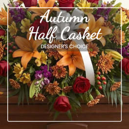 Autumn floral casket spray with lilies, roses, and mums