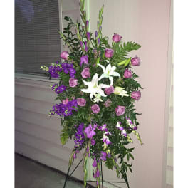 Tall standing floral spray with purple roses and white lilies