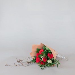 Bouquet of red roses wrapped in tan paper