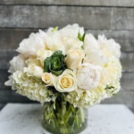White rose and hydrangea bouquet in a glass vase