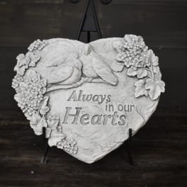 Heart-shaped memorial plaque with birds and flowers