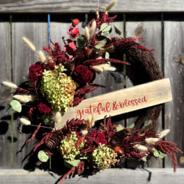 Fall wreath with dried flowers and a "grateful & blessed" sign
