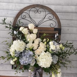 White and blush roses with hydrangeas in a glittery vase