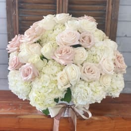 Large bouquet of pale pink and white roses with white hydrangeas