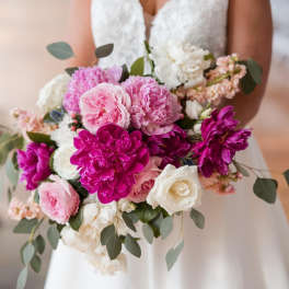 Bride holding a bouquet of pink, magenta, and white flowers