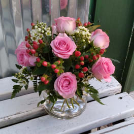 Pink roses arranged in a clear glass vase