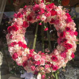 Large pink and white floral wreath on an easel