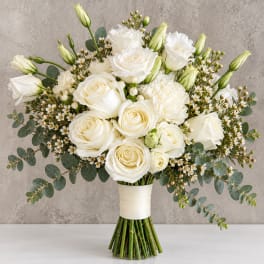 White rose and lisianthus bouquet with eucalyptus in a wrapped hand-tied design