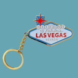 Las Vegas souvenir keychain with a gold ring and enamel sign charm