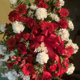 Large bouquet of red and white flowers with a red ribbon