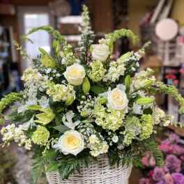 White roses and lilies in a white wicker basket