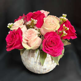 Pink and blush roses arranged in a mosaic vase