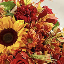 Autumn bouquet with sunflowers, red roses, and orange chrysanthemums