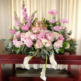 Pink floral casket spray with roses, lilies, and calla lilies