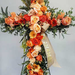 Orange and peach floral cross with roses and gerbera daisies