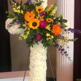 Standing floral cross with white flowers and bright mixed blooms