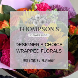 Wrapped bouquet of mixed flowers with a shop label overlay