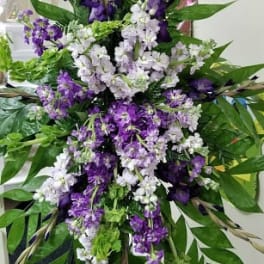 Tall purple and white floral standing spray on an easel