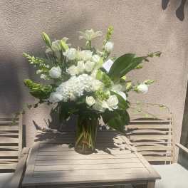 White floral arrangement in a clear glass vase