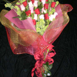 Bouquet of red and pink roses wrapped in pink and gold mesh