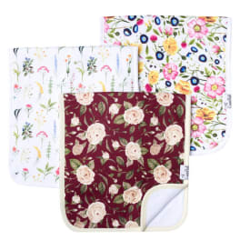 Three floral-patterned fabric placemats or mats stacked together